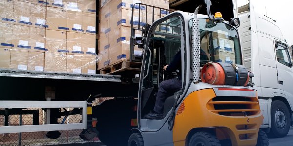 Forklift unloading a truck